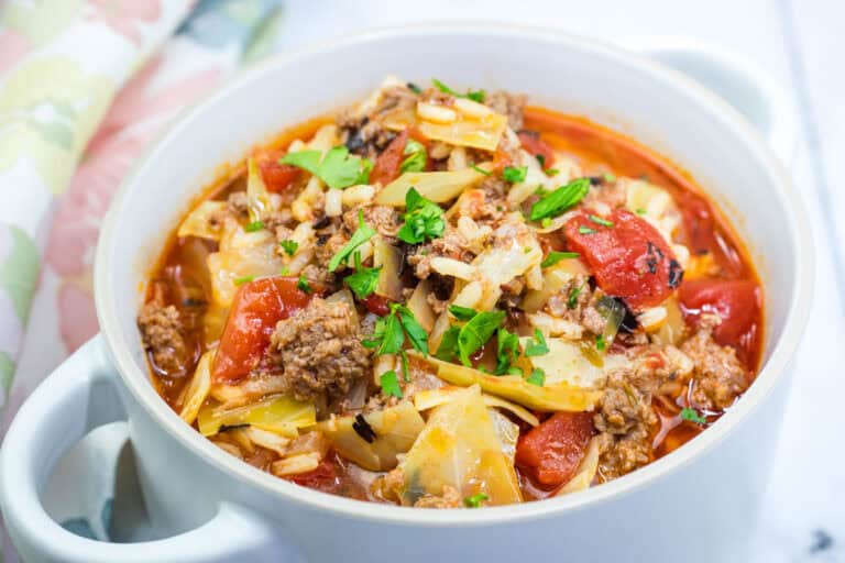 A delicious Meaty Cabbage Roll Soup in a white bowl.