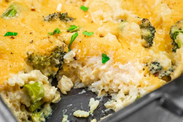 Close-up of Broccoli Rice Casserole in a baking dish, garnished with parsley.