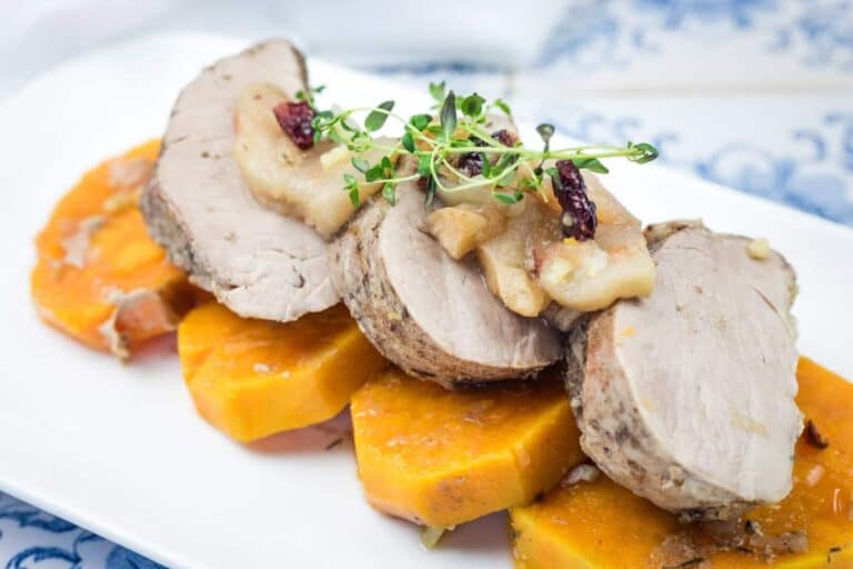 Pork Tenderloin with Sweet Potatoes and Apples served on a white platter.