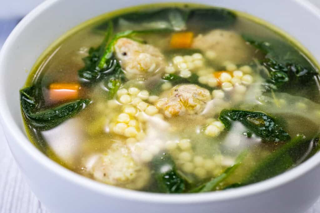 White bowl of Italian Wedding Soup.