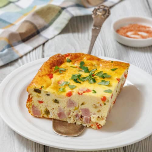 Slice of baked Western omelet on a white plate.