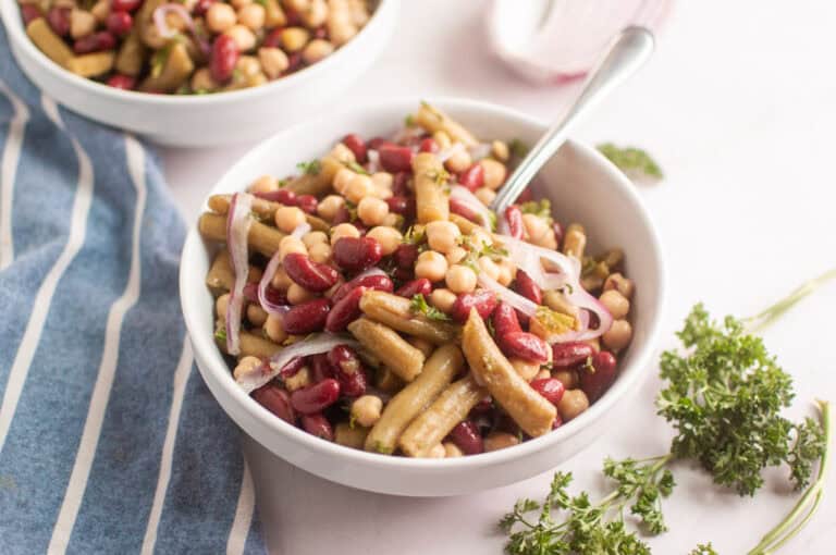 A white bowl of three bean salad.