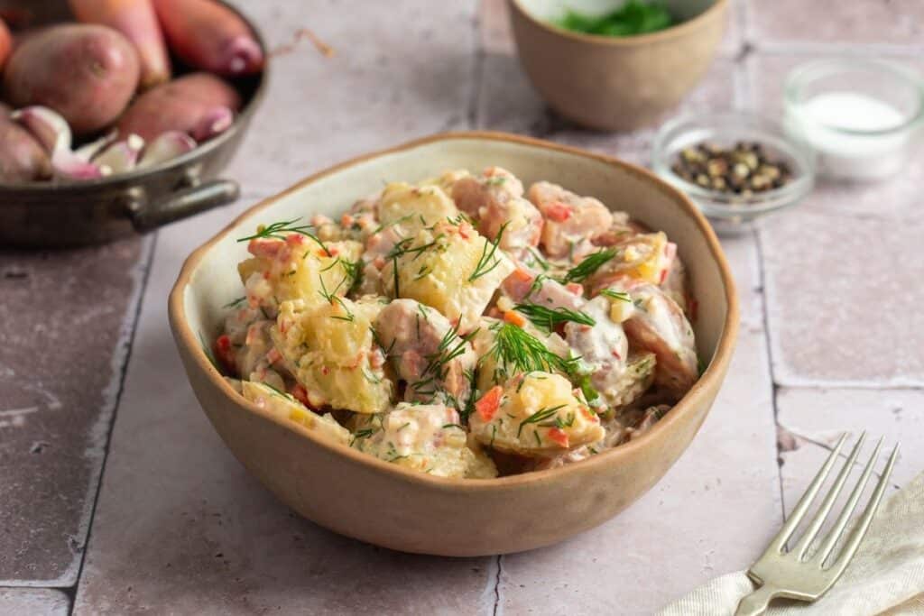 Creamy Red Potato Salad with Pickle that is in a bowl.
