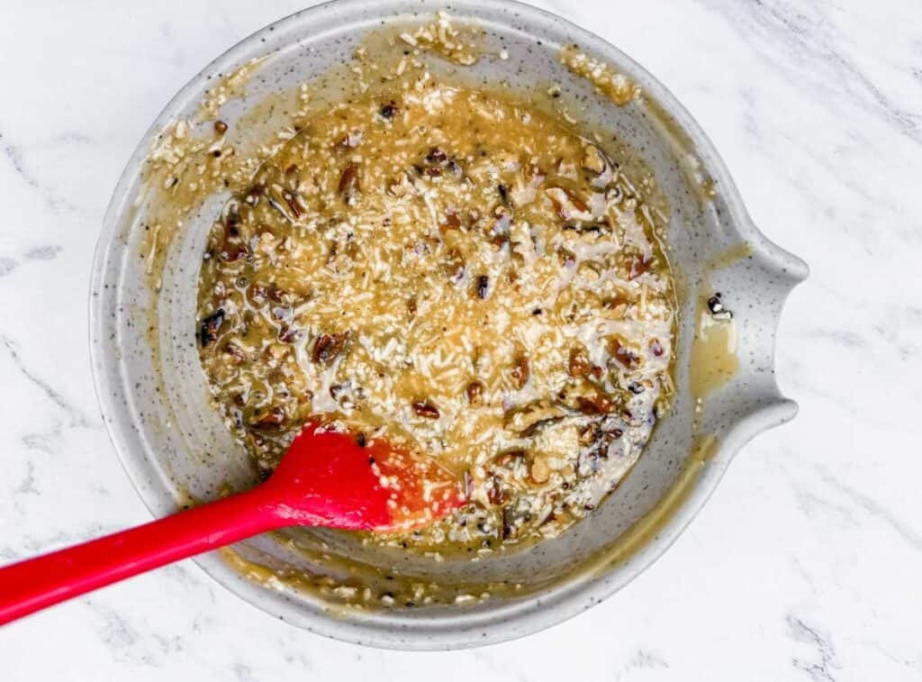 Bowl of German chocolate cupcake topping with coconut and pecans.