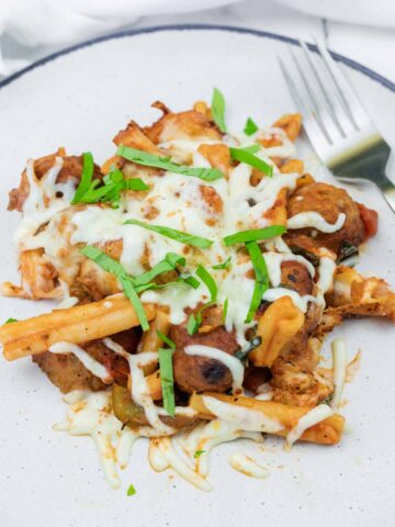 A plate of Mom's Meatball Casserole with a fork beside.