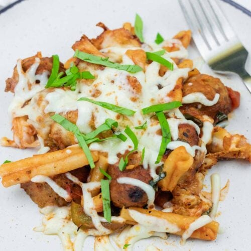 A plate of Mom's Meatball Casserole with a fork beside.