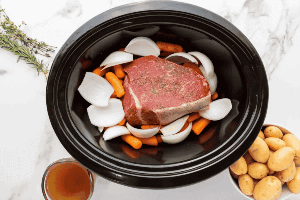 A slow cooker with meat and vegetables.